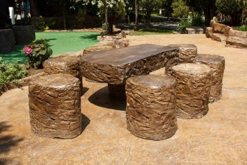 Concrete table and stools looks beautiful atop stamped patio