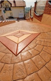 Stamped concrete walk with diamond center pattern descends hill